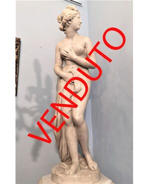 White marble statue with base, depicting Venus     